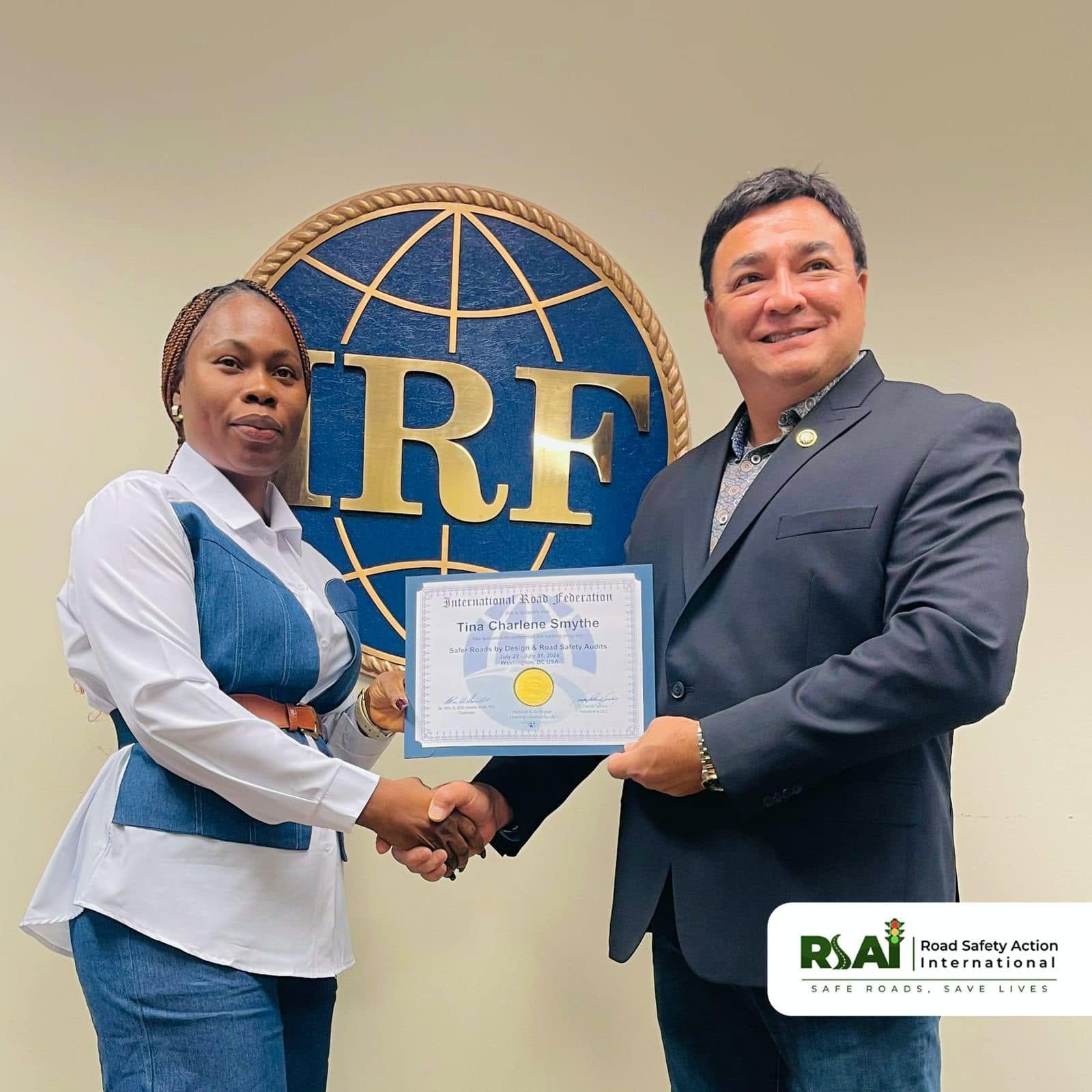 A participant receives her certificate from an IRF official.
