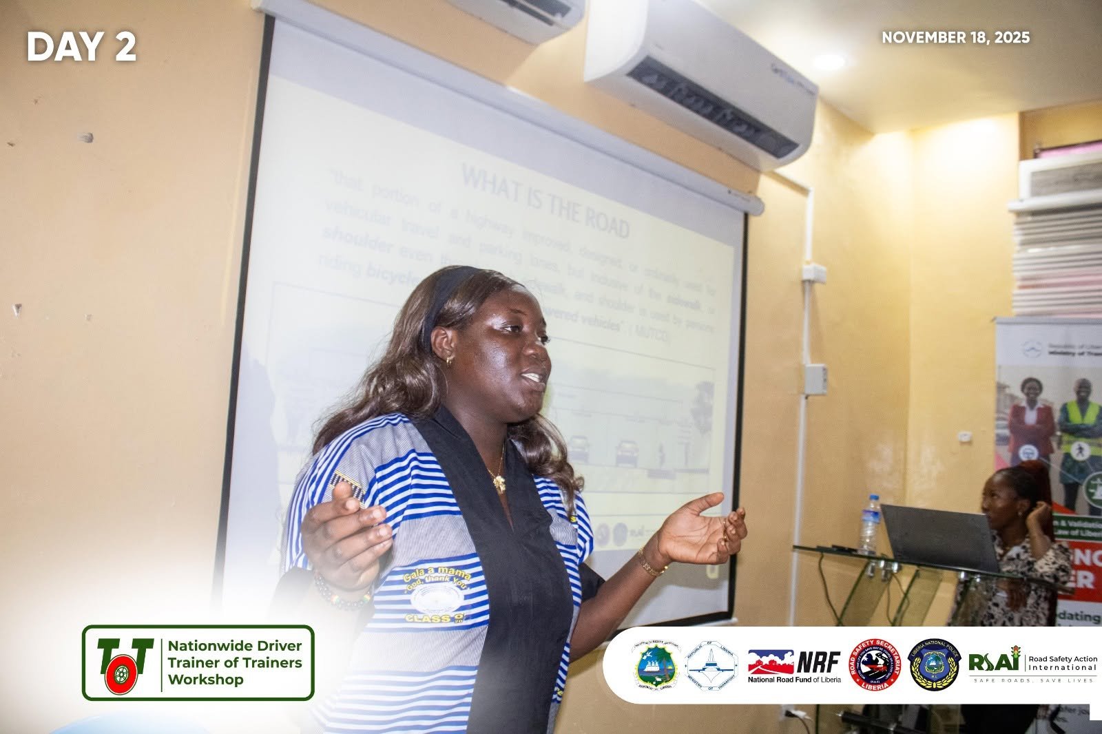 A facilitator presents the session “What is the road?” (Day 2, 18 November 2025).
